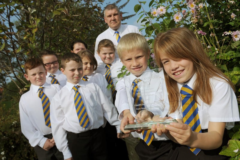 The Dunn Street Primary School gardening club members were celebrating in 2014 with headteacher Stewart Reader after they won a Northumbria in Bloom Award. Is there someone you know in this photo?