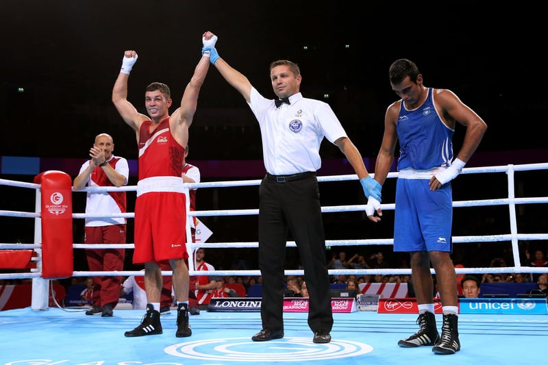 Scott Fitzgerald of England celebrates winning the gold medal against Mandeep Jangra of India in the Men's Welter (69kg) Final at SSE Hydro during day ten of the Glasgow 2014 Commonwealth Games .