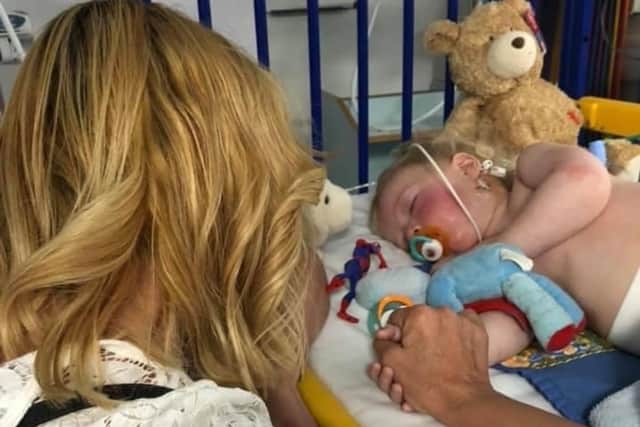 Two-year-old boy Jacob O'Neill was rushed to Sheffield Children’s Hospital with a potentially life threatening condition – just hours after being completely healthy. He is pictured  undergoing treatment at Sheffield Children's