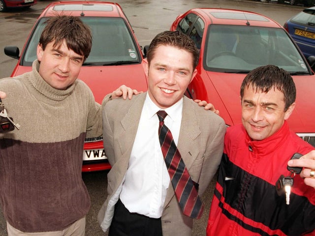 Dixon Rover sales executive James Kitching handed over the keys of the two sponsored cars to Doncaster Rovers FC managerial duo, boss Ian Snodin (left) and his brother and number two, Glynn Snodin in 1999