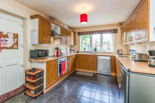 The main kitchen area is of a good size and boasts all the amenities you need, including a range of wood-effect wall and base units, integrated electric oven, stainless-steel sink and ceramic tiled floor.