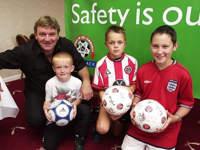 Tony Currie on the Football in the Community stand at the Sheffield United open day with young fans, left to right, Ryan Hancock, Thomas Thornhill and Robert Walsh, on August 4, 2002