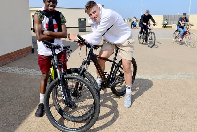 Josh Matthews, left, and Marc Mogie take a break from riding their bikes.