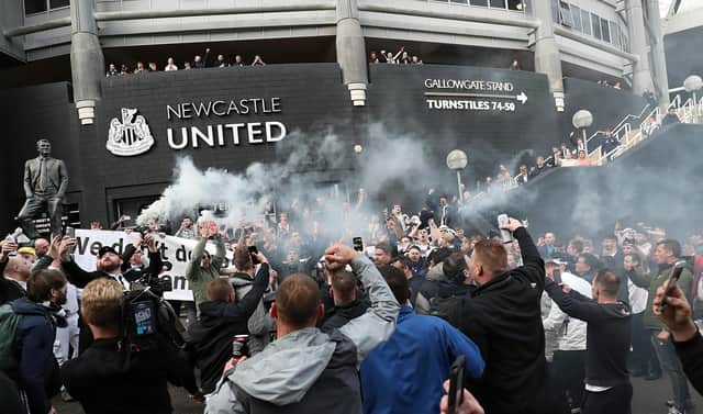 Newcastle United supporters celebrate outside the club's stadium St James' Park in Newcastle upon Tyne in northeast England on October 7, 2021, after the sale of the football club to a Saudi-led consortium was confirmed. (Photo by - / AFP) (Photo by -/AFP via Getty Images)