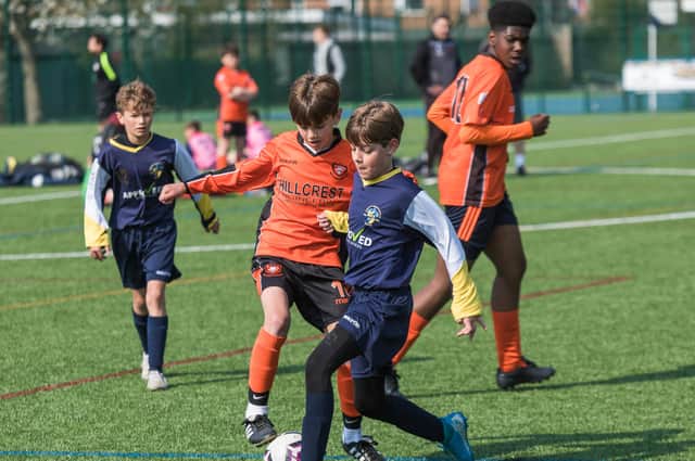 Action from Havant & Waterlooville under-12s clash with AFC Portchester Saxons under-12s (orange)