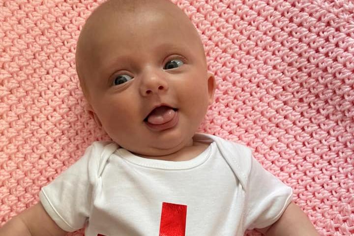 Sharnie Leigh's 10-week old baby rocking an 'it's coming home' babygrow.