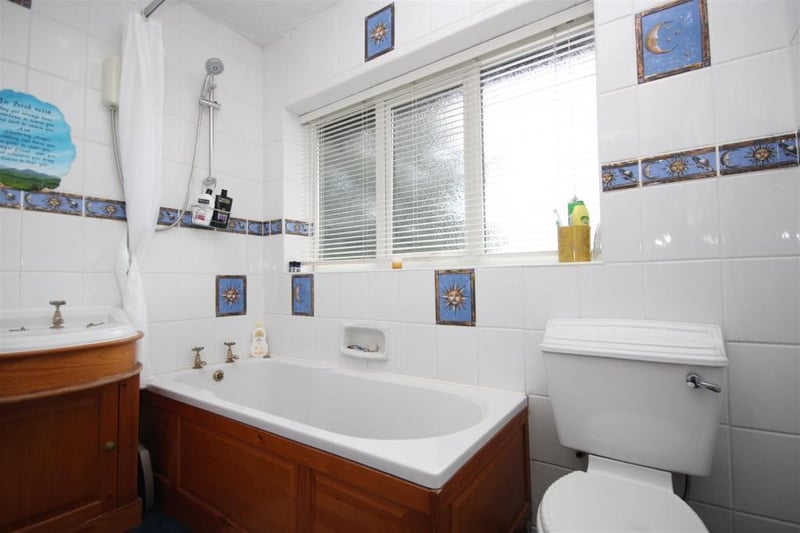 The family bathroom includes a panelled bath and shower over.