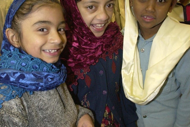 L/r: Aishah Tatiq (7), Shahana Bi (8) and Ahmed Dirir (7) from Greenlands Junior School, try on traditional clothes at the  Karachi Store, Atthercliffe in January 2001