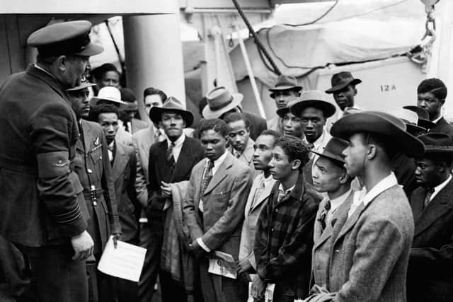Jamaican immigrants welcomed by RAF officials from the Colonial Office after the ex-troopship HMT 'Empire Windrush' landed them at Tilbury. Photo credit: PA Wire