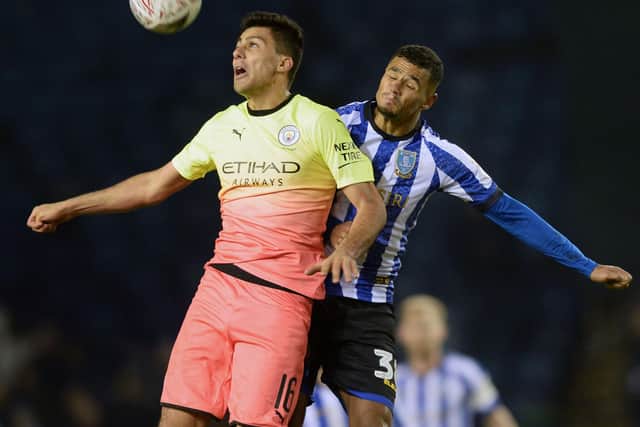 Sheffield Wednesday forward Alessio Da Cruz battles Manchester City's Rodri for the ball.