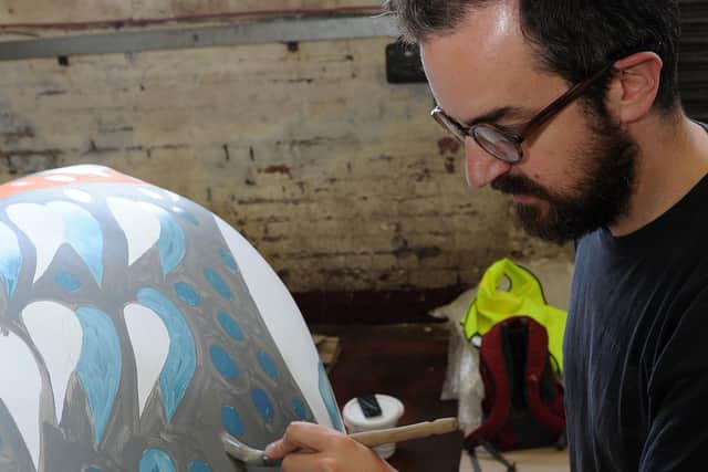 James Green painting his elephant as part of the Herd of Sheffield in 2016