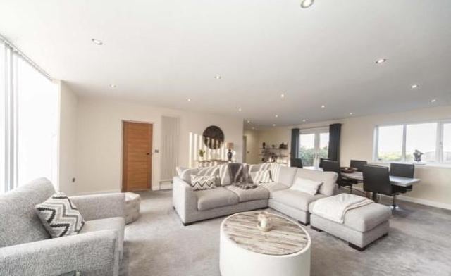 The lounge is spacious and has stunning full height windows to the front, plus double doors to the back, feature column radiators, contemporary decor, unusual feature fire with coal effect and under stairs storage cupboard.
