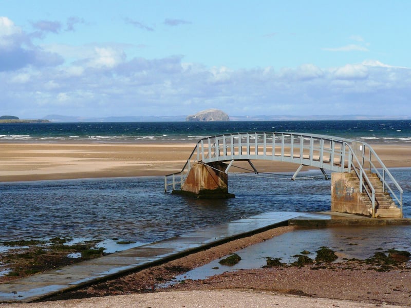This sweep of sand runs for nearly two miles on the fringes of John Muir Country Park. Known for its surfing, it's backed by the park's romantic tableau of sand dunes, salt marsh and woodlands. Crossing a stream at its eastern end is the "Bridge to Nowhere", which appears to have become marooned at high tide.