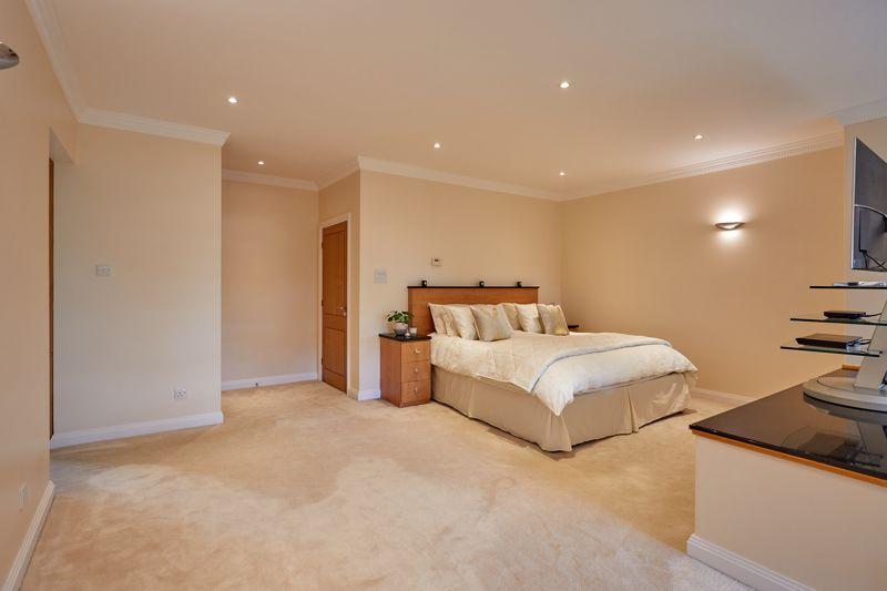 The expansive master bedroom features a dressing room and bathroom.