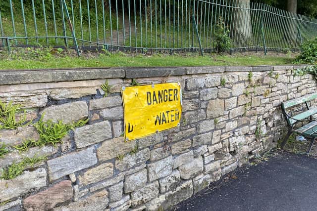 A sign beside the lake at Crookes Valley Park warning people of the danger