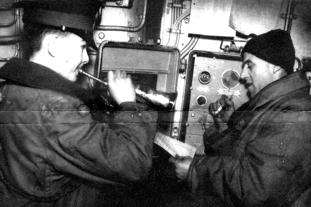 Sheffield bugler. Duty bosuns make a routine broadcast over HMS Sheffield's communications systems in 1941.