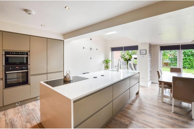 "This spacious open plan living has the kitchen area which has a central island with quartz work surfaces including the induction hob and sink unit with tap attachment," says the brochure.