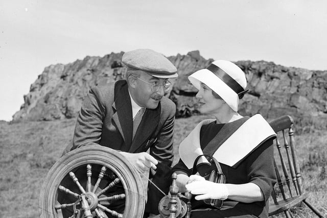 The film 'The Battle of the Sexes' was filmed in Edinburgh in 1959, with Arthur's Seat doubling as the Western Isles. Stars Peter Sellers and Constance Cummings are pictured with a spinning wheel in Holyrood Park.