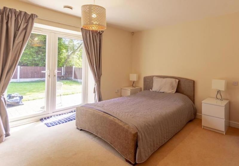 One of the five bedrooms at the property. It has fitted wardrobes, access to an en-suite and even its own patio doors.