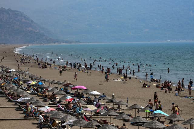 You can fly here from June 12. Pictured: People enjoy Iztuzu beach on August 16, 2019 in Dalaman, Turkey.