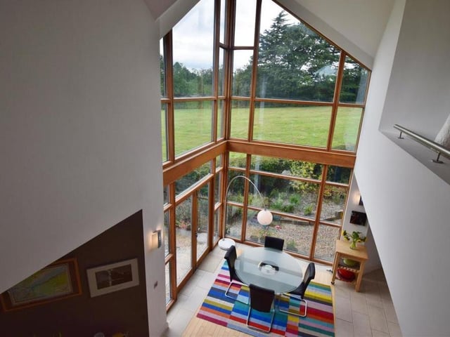 Looking down from the first floor to the family area below, this photo shows how open and bright the house is. Those windows and those views!