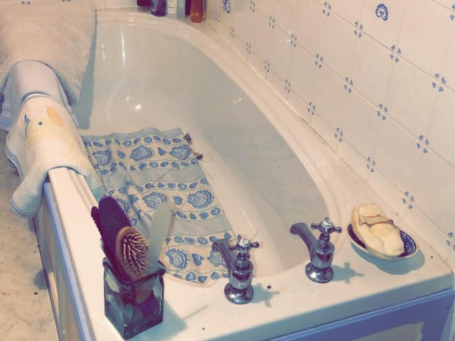 Products and soap still line the bath, waiting to be used.