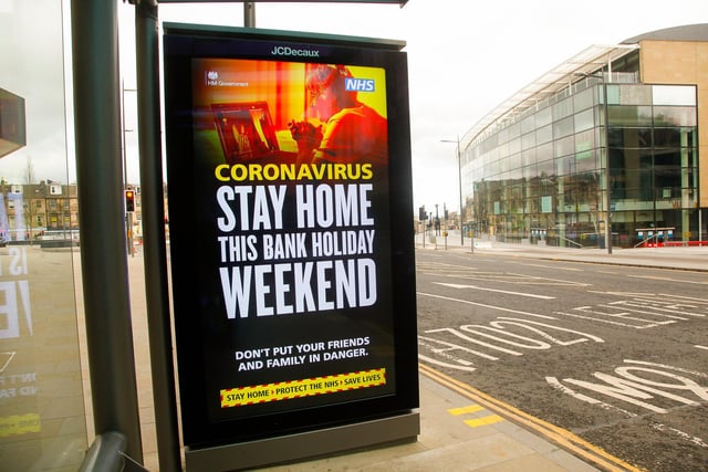 A sign at a bus stop outside John Lewis warns the public to stay at home this weekend.