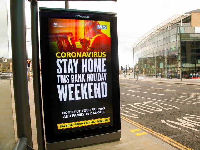 A sign at a bus stop outside John Lewis warns the public to stay at home this weekend.