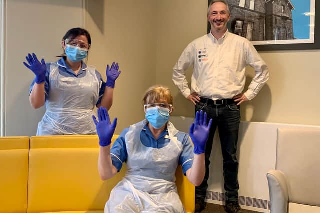 Claremont healthcare team donning their new protective equipment, pictured with Mark Holmes