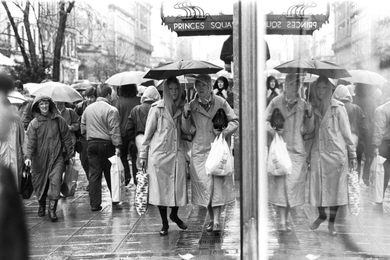 Heavy rain failed to stop the Glasgow bargain hunters outside Princes Square in Buchanan Street, December 1987.