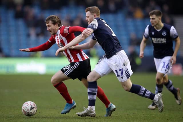 LONDON, ENGLAND - JANUARY 25: Luke Freeman of Sheffield United battles for possession with James Brown of Millwall during the FA Cup Fourth Round match between Millwall FC and Sheffield United at The Den on January 25, 2020 in London, England. (Photo by Alex Pantling/Getty Images)