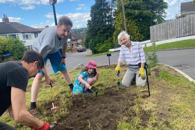 Councillor Barbara Masters planting wildflowers with the community.