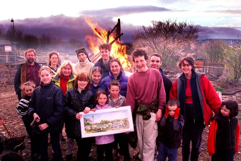 A community  bonfire was lit at Heeley City Farm on the site of what would be new stables to replace the ones gutted by arsonists. Seen are farm workers and supporters with a picture of the new buildings, with the bonfire behind them, on March 17, 2000
