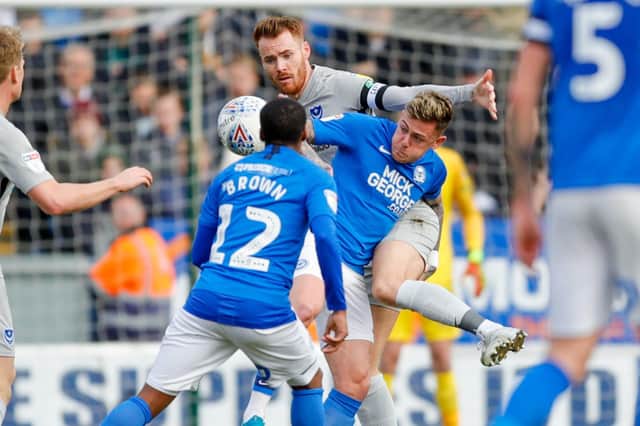 Portsmouth midfielder Tom Naylor (4) battles with Peterborough United midfielder Sammie Szmodics (9), on loan from Bristol City,  during the EFL Sky Bet League 1 match between Peterborough United and Portsmouth at London Road, Peterborough, England on 7 March 2020.