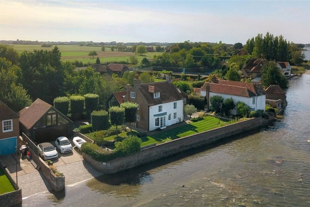 Based in a superb harbourside location, this seven bedroom property features modern fixtures and fittings throughout, and benefits from a home office, annexe, a heated swimming pool and a private jetty. Price: £4,250,000.