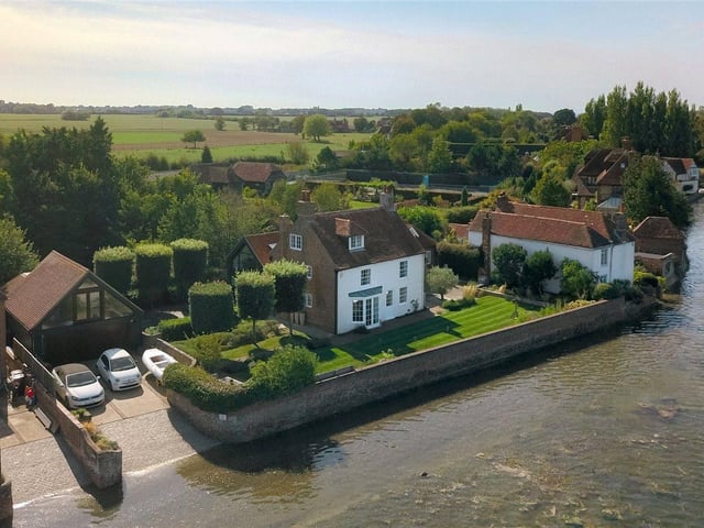 Based in a superb harbourside location, this seven bedroom property features modern fixtures and fittings throughout, and benefits from a home office, annexe, a heated swimming pool and a private jetty. Price: £4,250,000.