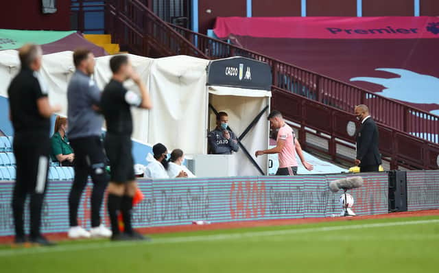 BIRMINGHAM, ENGLAND - SEPTEMBER 21: John Egan of Sheffield United leaves the field of play after receiving a red card following a VAR review during the Premier League match between Aston Villa and Sheffield United at Villa Park on September 21, 2020 in Birmingham, England. (Photo by Julian Finney/Getty Images)
