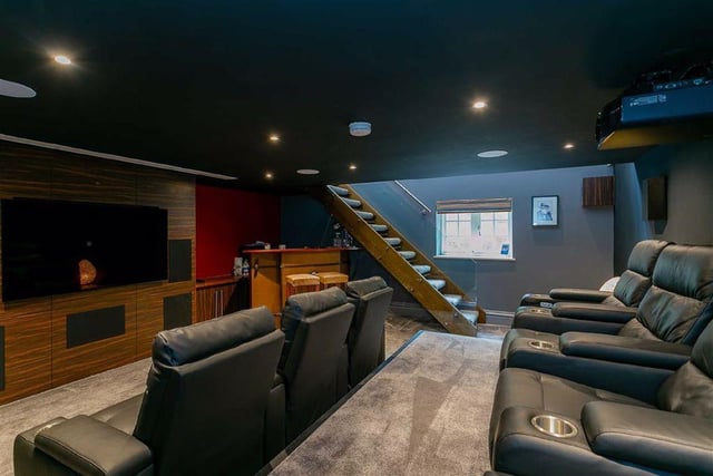 Stairs lead down to the cosy cinema and entertainment room, which is fitted with a 65 inch oled Smart television and comfy leather seats.