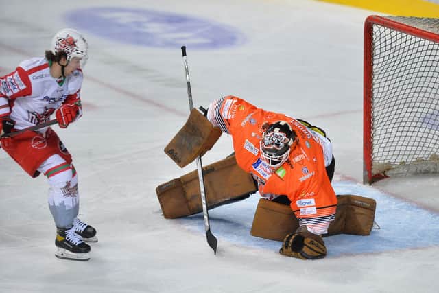 Barry Brust grabs the puck to thwart a Cardiff Devils attack