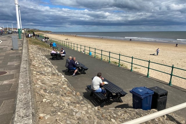 People can be seen enjoying some fish and chips by the seaside but followed social distancing guidelines as they ate.