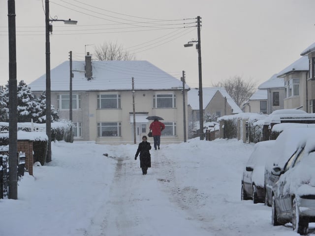 People make their way through streets in Garrowhill, Glasgow, November 2010