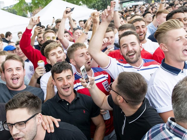 Football fans watch the World Cup semi-final between England and Croatia at Devonshire Green in Sheffield, on July 11, 2018