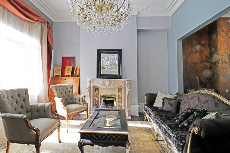 The period fireplace takes centre stage in the living room.
