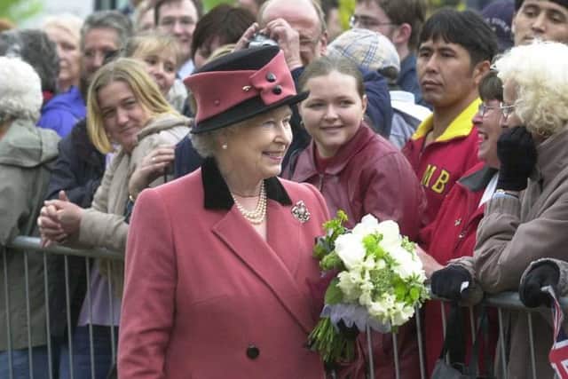 Queen Elizabeth II meeting people in the crowds who came to see her in Sheffield during her visit in 2003.