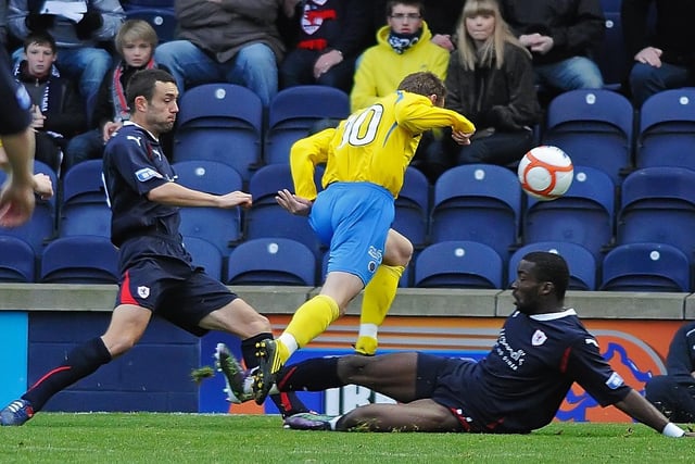 Laurie Ellis and Gregory Tade combine to stop a Queens attack in this league match back in November 2010.
