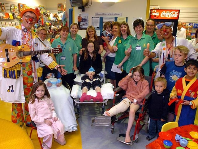 Two special clown doctors from The Theodora Children's Trust came to the Sheffield Children's Hospital to bring a smile to patients and staff alike. The Doctors, Dr Gee Hee (Faith Tingle) and Dr Strumalong (Patrick Jacobs) with staff and patients in the main reception, on May 20, 2005