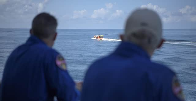 NASA astronaut and Crew Recovery Chief Shane Kimbrough, left, and NASA Chief Astronaut Pat Forrester watch as SpaceX support teams are deployed on fast boats from the SpaceX GO Navigator recovery ship ahead of the landing of the SpaceX Crew Dragon Endeavour spacecraft with NASA astronauts Robert Behnken and Douglas Hurley onboard, Sunday, Aug. 2, 2020, in the Gulf of Mexico off the coast of Pensacola, Fla. (Bill Ingalls/NASA via AP)