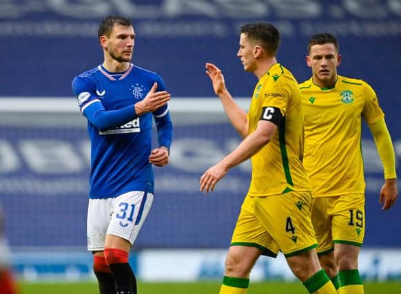 Borna Barisic (L) and Hibernian's Paul Hanlon shake hands at full time during the Scottish Premiership match between Rangers and Hibernian at Ibrox Stadium on December 26, 2020, in Glasgow, Scotland. (Photo by Rob Casey / SNS Group)