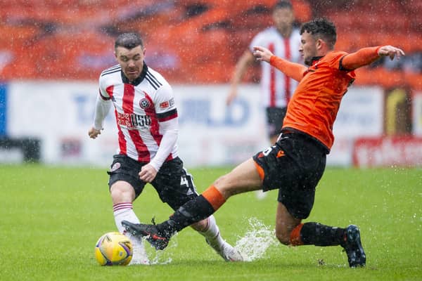 John Fleck in action against Dundee United at Tannadice illustrating the conditions which saw the match abandoned at half time with the Blades 1-0 up through Billy Sharp