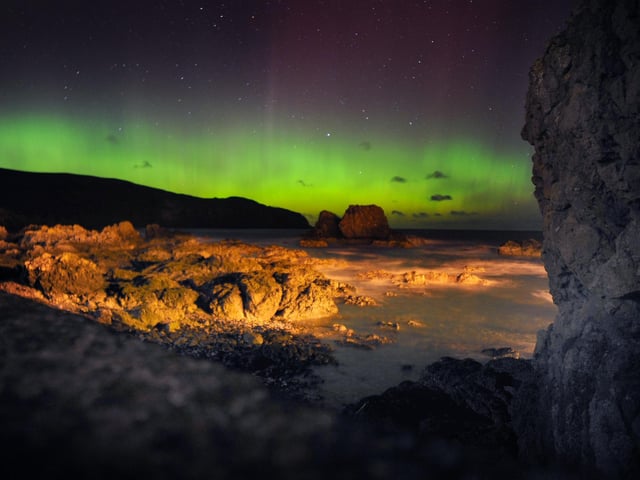 The aurora borealis dancing over St Abbs head.
